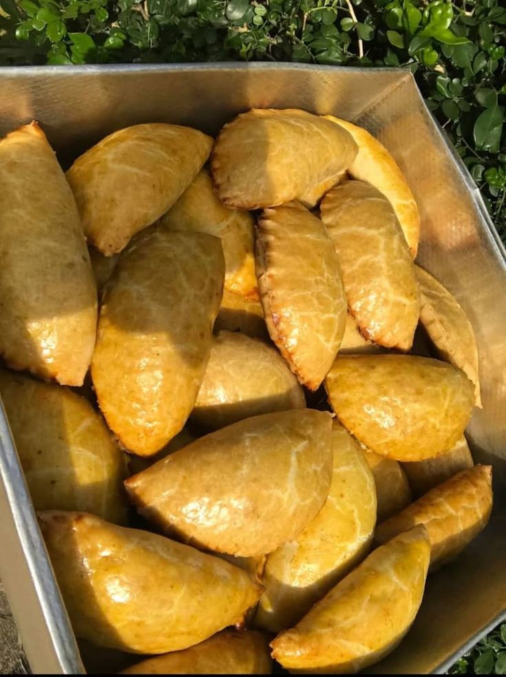 Tray of golden, glossy freshly baked Nigerian meat pies