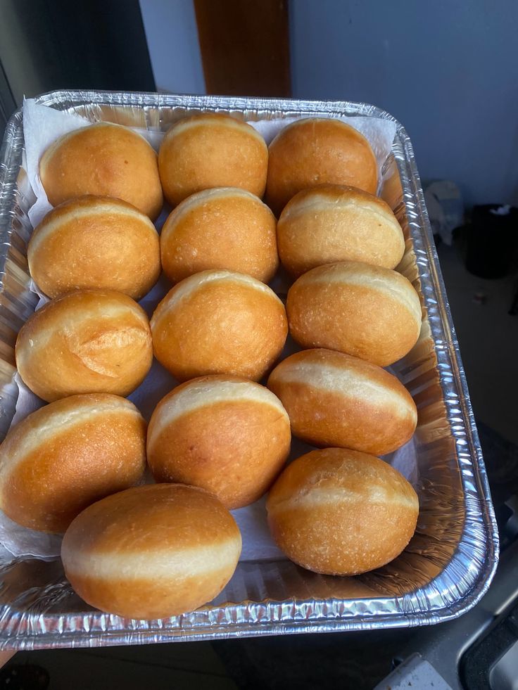 Tray of freshly fried golden buns with a soft white band